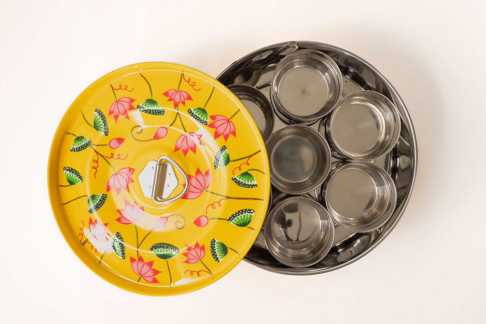 Yellow pichhwai enamel masala dabba with lotus design. Empty.