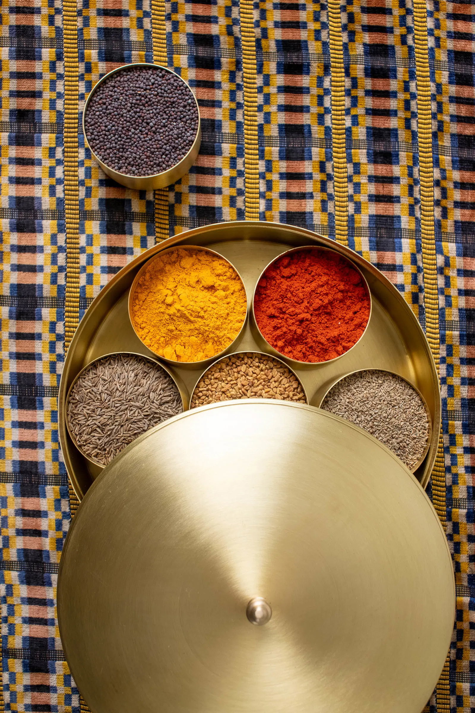 Top view of masala dabba, filled with spices