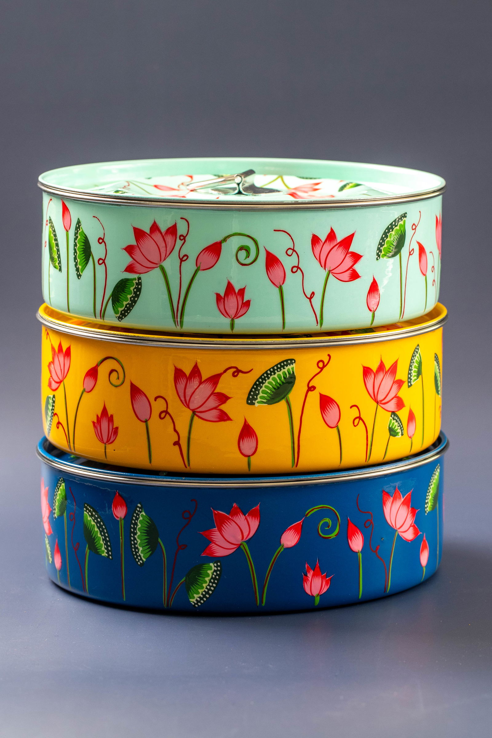 Stack of hand-painted lotus dabbas.