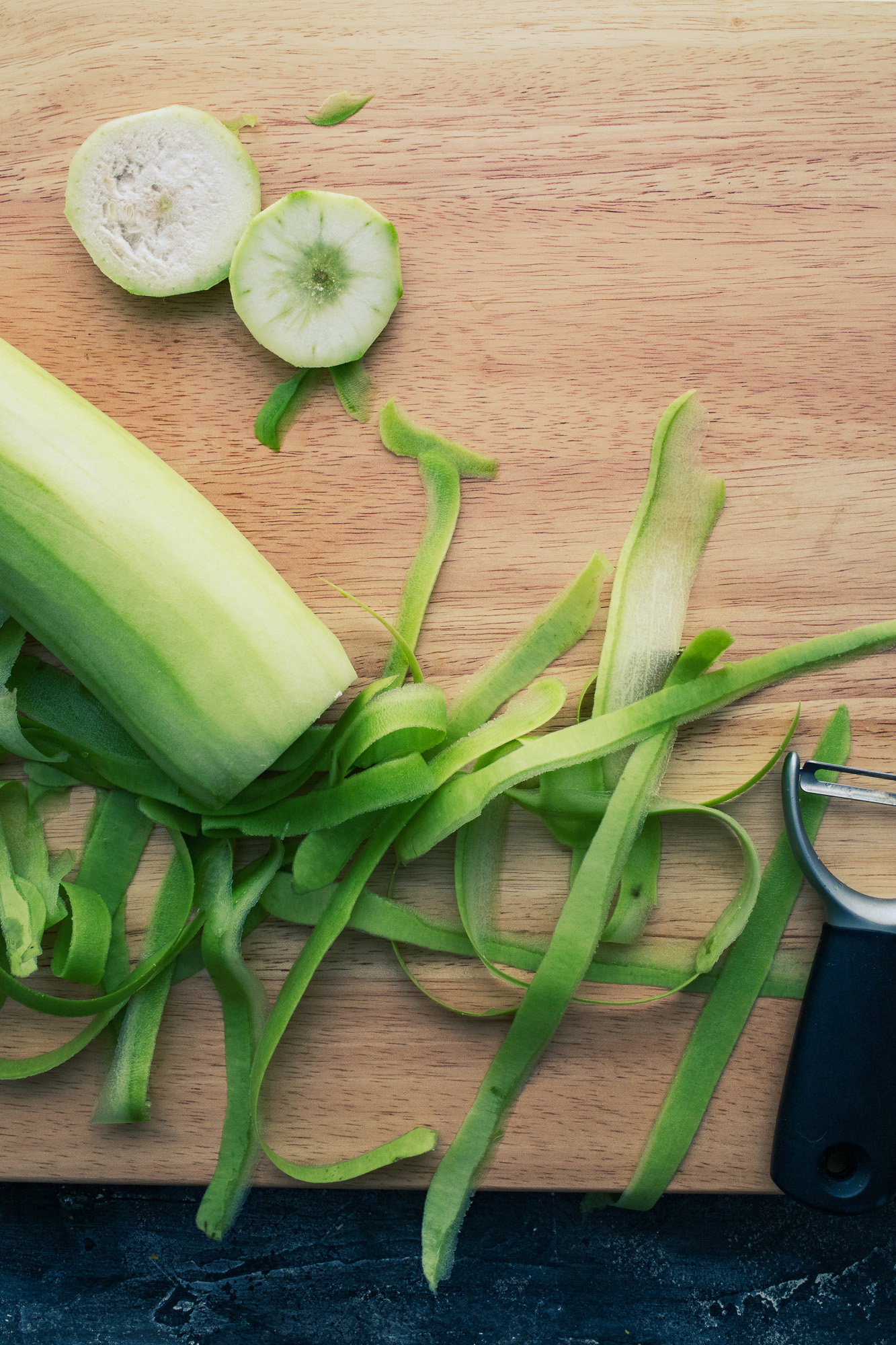 Kitchen shot of dudhi, peeled and some slices.